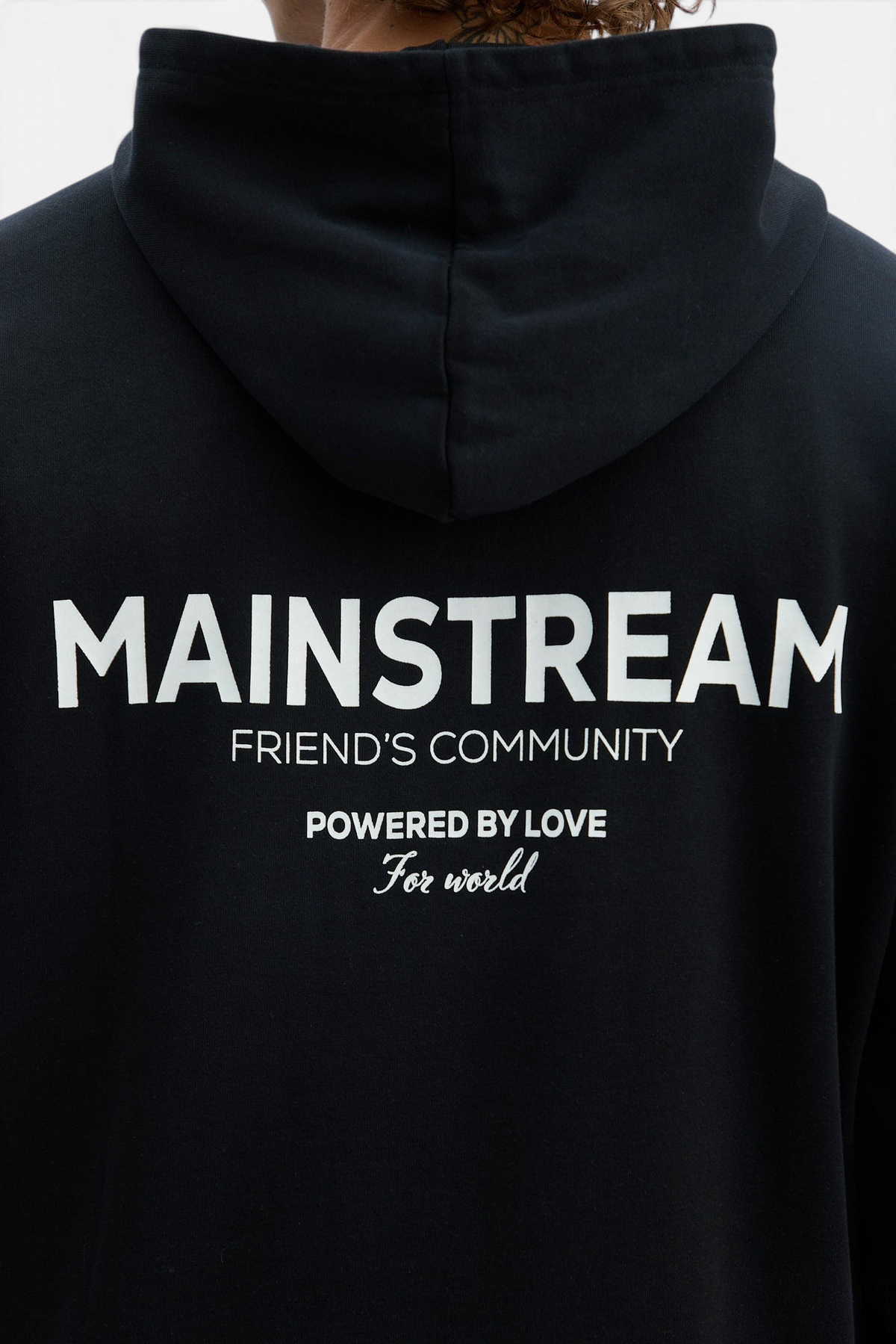 Mainstreamonline black oversized hoodie with white graphic print on the back featuring Friend's Community text