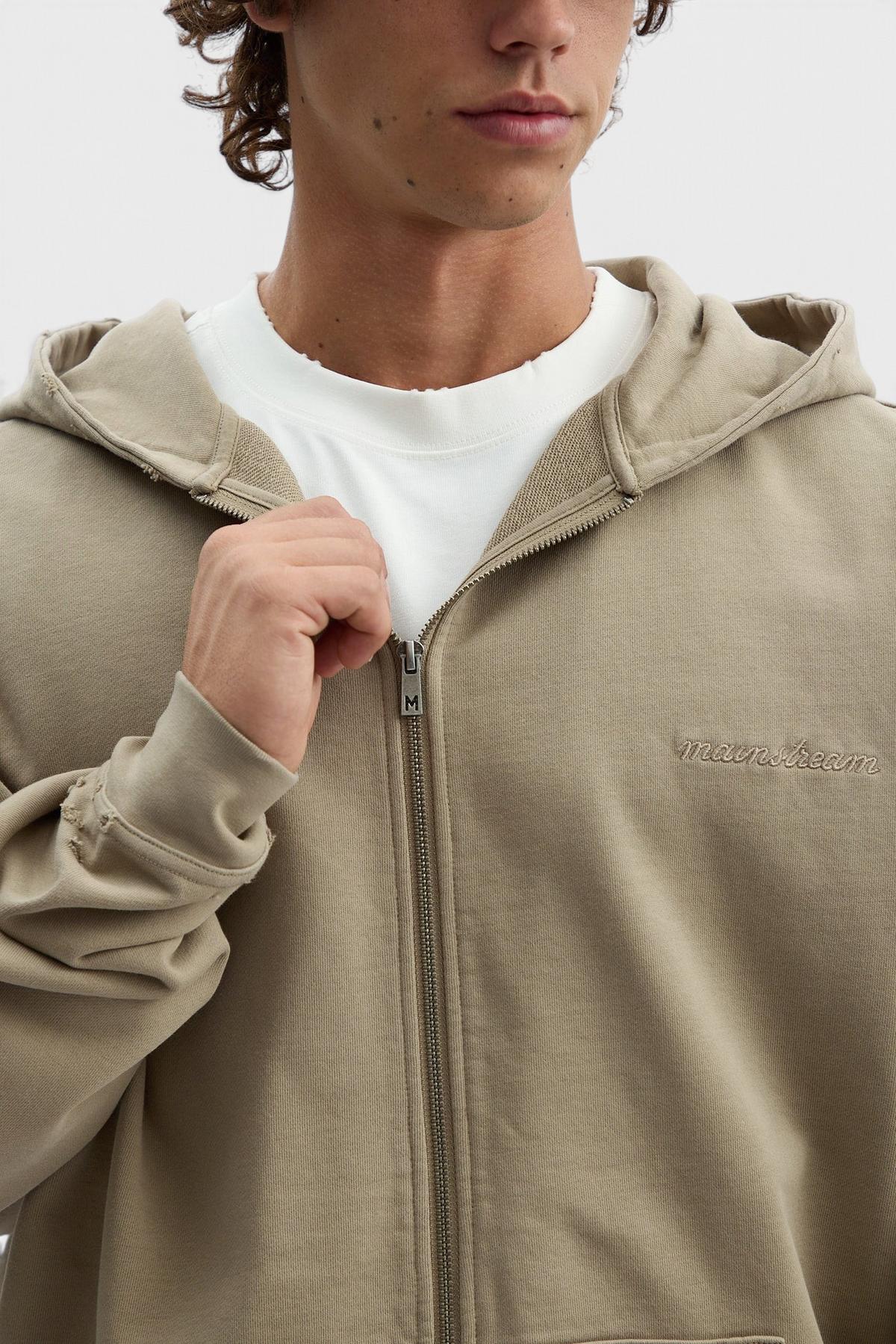 Mainstreamonline Rifts oversized beige zip-up hoodie with distressed cuff detail worn by a model