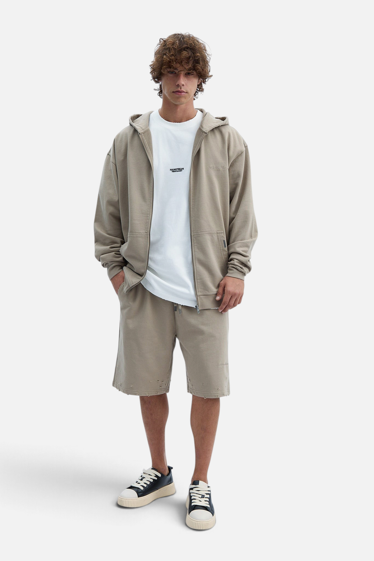 Mainstreamonline Rifts oversized beige zip hoodie worn by a male model with matching shorts and white t-shirt