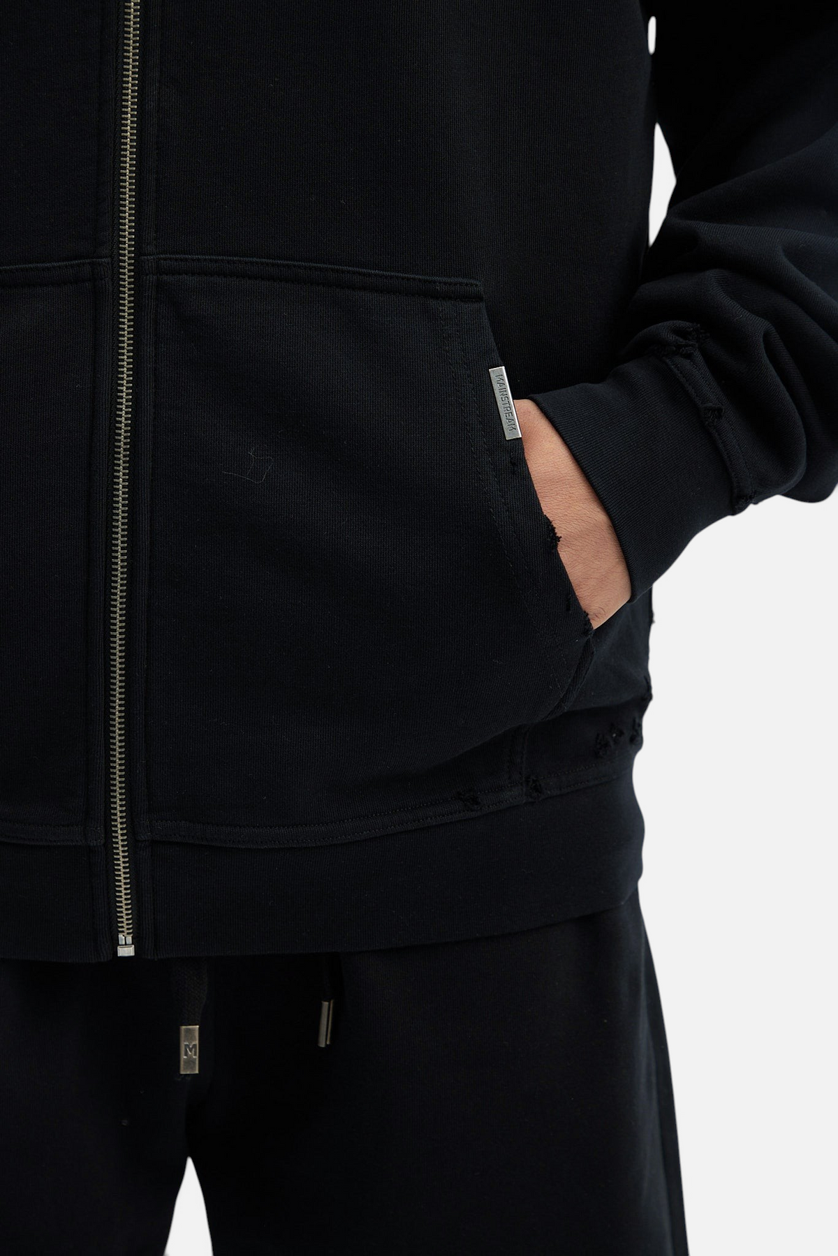 Mainstreamonline Rifts black oversized zip-up hoodie with distressed pocket detail and metal zipper