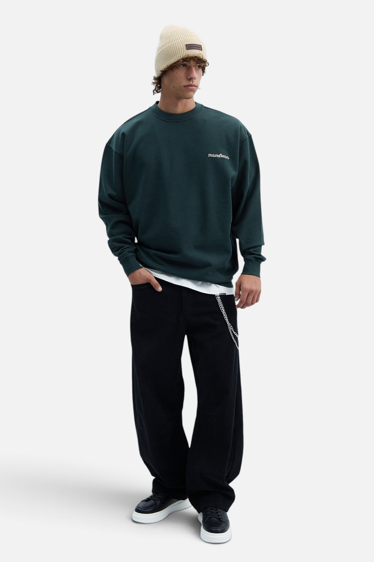 Mainstreamonline beige wool beanie worn by a male model in a dark green sweatshirt and black trousers