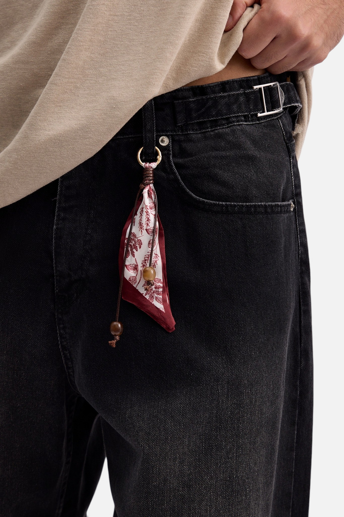 Mainstreamonline black baggy skater jeans with a decorative patterned fabric charm attached to the belt loop